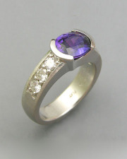 Other Rings 1-11: Oval purple sapphire in platinum with bead set diamonds down the sides