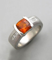 Other Rings 1-3: Cushion cut orange sapphire with channel set princess cut diamonds in white gold