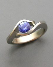Other Rings 1-4: Round cut blue sapphire partial bezel set in white gold