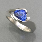 Other Rings 2-11: Triangular cut blue sapphire in a partial bezel set in white gold