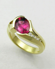 Other Rings 2-4: Oval rhodolite garnet in a partial bezel with channel set diamonds in yellow gold
