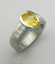 Other Rings 2-9: Oval cut yellow sapphire partial bezel set with princess cut diamonds on the sides in platinum