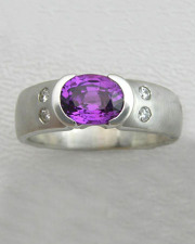 Other Rings 3-10: Oval purple sapphire in a partial bezel with flush set diamonds on the sides in white gold