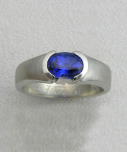 Other Rings 3-4: Oval blue sapphire partial bezel set in white gold