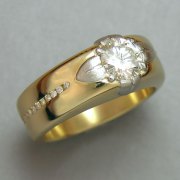 Other Rings 1-12: Round cut diamond set in a platinum lotus flower with channel set diamonds down the sides in yellow gold