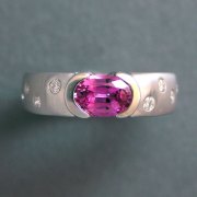 Other Rings 2-6: Oval pink sapphire partial bezel set with scattered diamonds on the sides in white gold