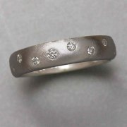 Bands 1-2: Small full cut diamonds flush set in a scattered pattern in white gold