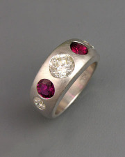 Bands 2-7: Round cut diamonds and rubies flush set in white gold