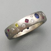 Bands 3-12: Various shaped flush set clear and yellow diamonds, rubies and blue sapphires in platinum