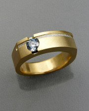 Bands 3-3: Round cut blue sapphire bezel set in yellow gold with a recessed textured platinum inlay