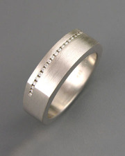 Bands 3-5: Small diamonds channel set across the top of a squared white gold band