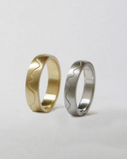 Bands 1-12: 14kt. yellow and white gold custom bands with curved center line