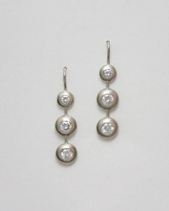 14kt. white gold three stone diamond bezel drop earrings