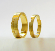 18kt. yellow gold custom matching bands with stone motif (two bands key into each other)