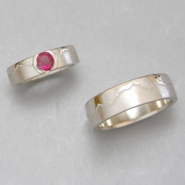 Mountain Bands 1-12: 14-karat white gold skyline ruby engagement ring and matching wedding band