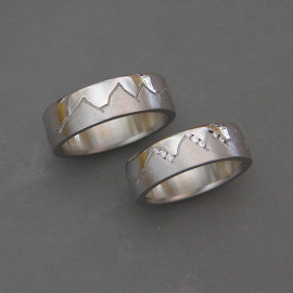 Pair of 14k White gold Misc Mountain bands with Diamonds channel set into Ladies version