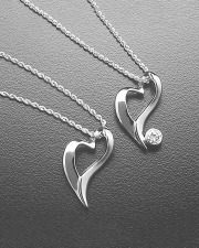 Necklace 1-10: Two floating heart pendants in white gold. One plain and one with a full bezel set diamond
