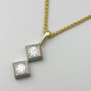 Necklace 1-11: Round cut diamonds prong set in two square white gold frames with yellow gold details