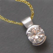 Necklace 1-9: Round cut diamond in a partial bezel in white gold
