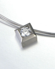Necklace 2-5: Round cut diamond prong set in a square frame in white gold