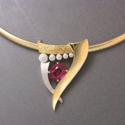 Necklace 2-6: Oval ruby in prongs with full bezel set diamonds in white and yellow gold