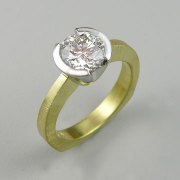 Engagement Ring 1-12: Round cut diamond partial bezel set in platinum and 18k yellow gold