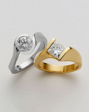 Engagement Ring 1-5: Round cut diamond partial bezel set in white gold and a Princess cut diamond in a yellow gold channel setting