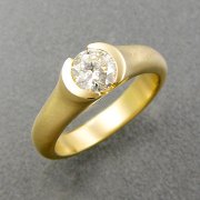 Engagement Ring 1-6: Round cut diamond in an 18k yellow gold partial bezel setting