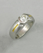 Engagement Ring 1-7: Round cut diamond in a 14k white gold partial bezel setting with 24k yellow gold inlay