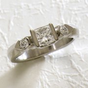 Engagement Ring 1-9: Princess cut diamond channel set with partial bezel set round side diamonds in white gold