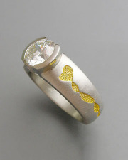 Engagement Ring 2-11: Round cut diamond partial bezel set in platinum with 24k yellow gold detailing