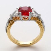 Engagement Ring 2-12: Round cut ruby prong set in platinum, and 18k yellow gold with triangular diamonds on the sides