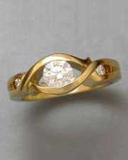 Engagement Ring 2-2: Round cut diamond partial bezel set in yellow gold with small diamonds on the side