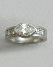 Engagement Ring 3-6: Marquise cut diamond full bezel set in white gold with bead set diamonds on the sides