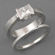 Engagement Ring 3-9: Princess cut diamond channel set in white gold with diamonds on the side shown with matching band