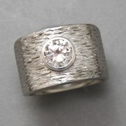 Engagement Ring 4-1: Round cut diamond full bezel set in white gold with a textured finish