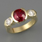 Engagement Ring 4-2: Round cut ruby partial bezel set in yellow gold with partial bezel set side diamonds