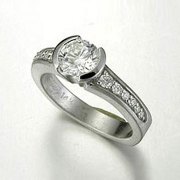 Engagement Ring 5-10: Round cut diamond partial bezel set in white gold with bead set diamonds on the sides