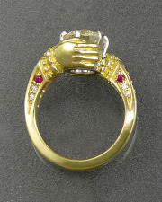 Engagement Ring 5-12: Round cut diamond prong set in 18karat yellow gold with bead set rubies on the sides