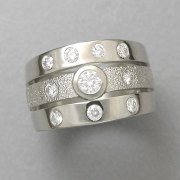 Engagement Ring 5-5: Round cut diamonds bezel and flush set in white gold