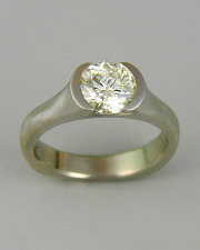 Engagement Ring 5-6: Round cut diamond partial bezel set in platinum