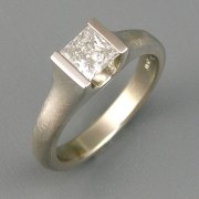 Engagement Ring 6-2: Princess cut diamond channel set in white gold