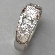 Engagement Ring 7-1: Round cut diamond prong set in white gold with gingko leaf detail