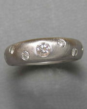 Engagement Ring 7-10: Several round cut diamonds flush set in white gold