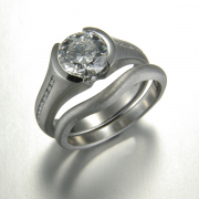 Engagement Ring 8-1: Platinum diamond engagement set with partial bezel set center diamond and channel set side diamonds and a custom contoured matching wedding band