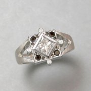 Engagement Ring 8-10: 14kt. white gold engagement ring with princess cut diamond in center surrounded by black diamonds
