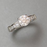 Engagement Ring 8-6: 14kt. white gold diamond engagement ring with prong set round diamond in center and bead set diamonds on each side