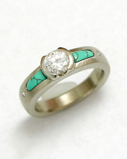 Engagement Ring 8-7: 14kt. white gold engagement ring with a round diamond partial bezel set in center and inlaid turquoise on each side
