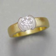 Engagement Ring 8-8: 18kt. yellow gold diamond engagement ring with center round diamond partially bezel set in a Platinum bezel