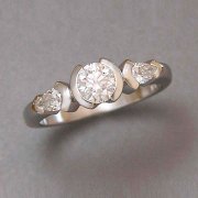 Engagement Ring 9-5: 14kt. white gold three stone diamond engagement ring with round diamond in center and a pear shaped diamond on each side
